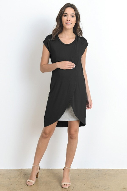 A black short sleeve maternity and nursing dress featuring a rounded neck line, an asymmetrical hem and grey underlining.