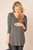 Charcoal jersey knit long line maternity top with 3/4 sleeves, crossed strap detail in front, and rounded hem.


Origin : USA