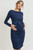 A navy long sleeve maternity dress featuring a front tie and side ruching. Wear this dress during pregnancy and afterward! Lift front tie detail for convenient access to chest for nursing or to pump!