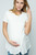 An ivory short sleeve maternity and nursing top featuring a rounded neckline.