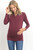 A burgundy long sleeve maternity and nursing top featuring a v-neck and wrap accent.