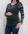 An olive green raglan sleeve maternity sweater top made of super soft knit material featuring a rounded neck and an ornate winter print on the sleeves.