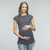 A striped maternity top featuring cap sleeves, high neck line and tied ruched sides.