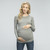 A fitted maternity top in a ribbed knit material featuring a rounded neckline, long sleeves and ruched sides.