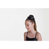 Girl wearing Studio 7 Dancewear Glitter Mini hat clip in Metallic black 