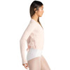 Woman wearing Capezio ballet knit wrap sweater top in pink, side view