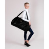 Energetiks Nova Duffle Bag worn with the shoulder strap to show the large scale and professional studio style.

