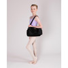 Female dancer wearing the Nova Dance Bag using the adjustable, padded shoulder strap to demonstrate its compact scale and comfortable carry.