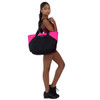 Girl carrying Studio 7 Dancewear Tilly Tote dance bag in Black and Neon Pink over her shoulder