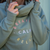 Embroidered " Breathe Calm Relax " Cross Neck Hoodie in Dusty Green - Percy and Nell Retail Limited