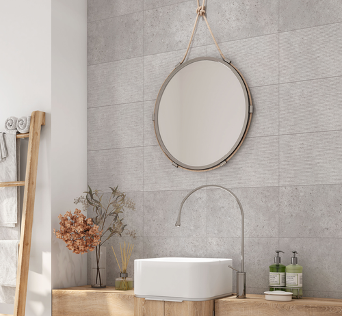 Grey stone effect ceramic tiles on a bathroom wall