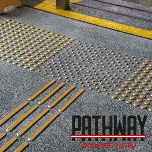 Genesis FTCA Pathway Shanked Stainless Steel Corduroy Tactile in yellow used on a concrete floor