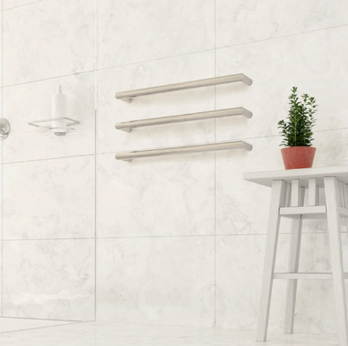 Double ended heated towel rails from ThermoSphere in a white marble bathroom