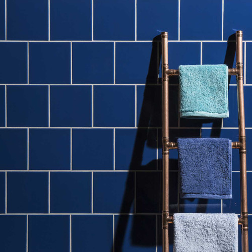 Johnsons Prismatics Square Victorian Navy Blue Tiles used in a bathroom with hanging towels