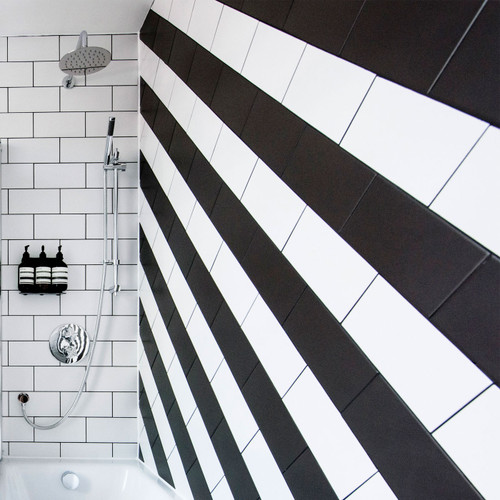 Johnsons Prismatics Matt Black Metro Tiles used in a striped pattern on a bathroom wall