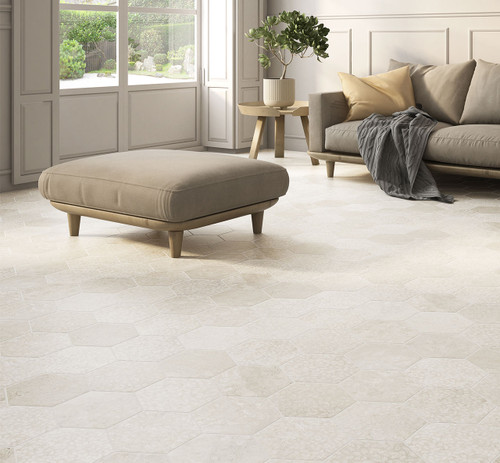 Tranquil Tones Almond Hexagon Tiles used in a large calming stone effect living room with a sofa and natural light