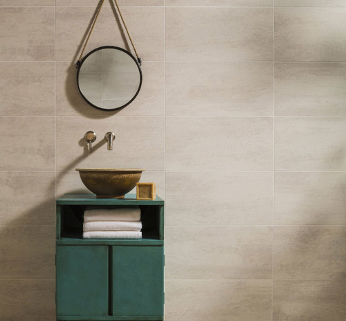 Johnsons Ashlar Warm Taupe Stone Effect Wall Tiles used on the wall of a bathroom with a green unit and a mirror