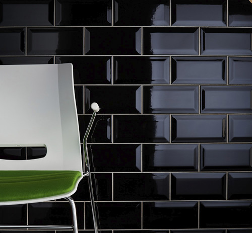 Johnsons Bevel Brick Black Gloss Wall Tiles used as shiny black wall tiles with a white plastic chair