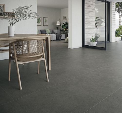 square dark grey cement effect floor tile used in an open plan house