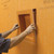 A tiler installing a Schluter Kerdi Board SN Tileable Shower Niche in a wet room construction.