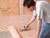 A tiler applying waterproofing Schluter Kerdi 200 Membrane to tile adhesive on the floor