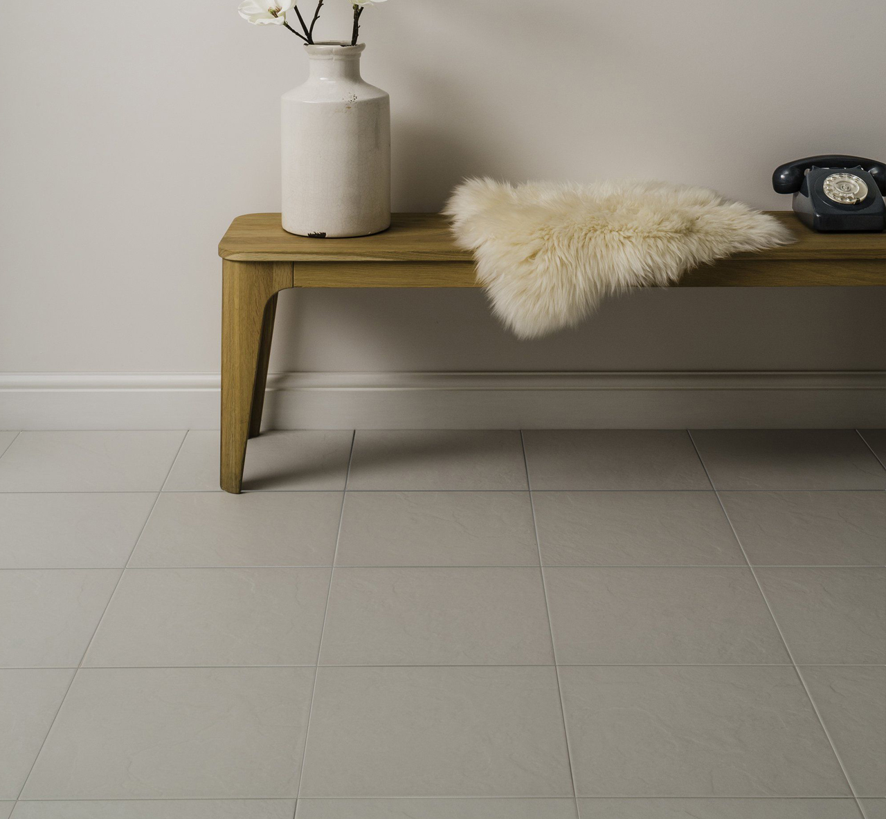 Johnsons Lagos White Slate Effect Porcelain Tiles used in a light hallways with furniture and a potted plant