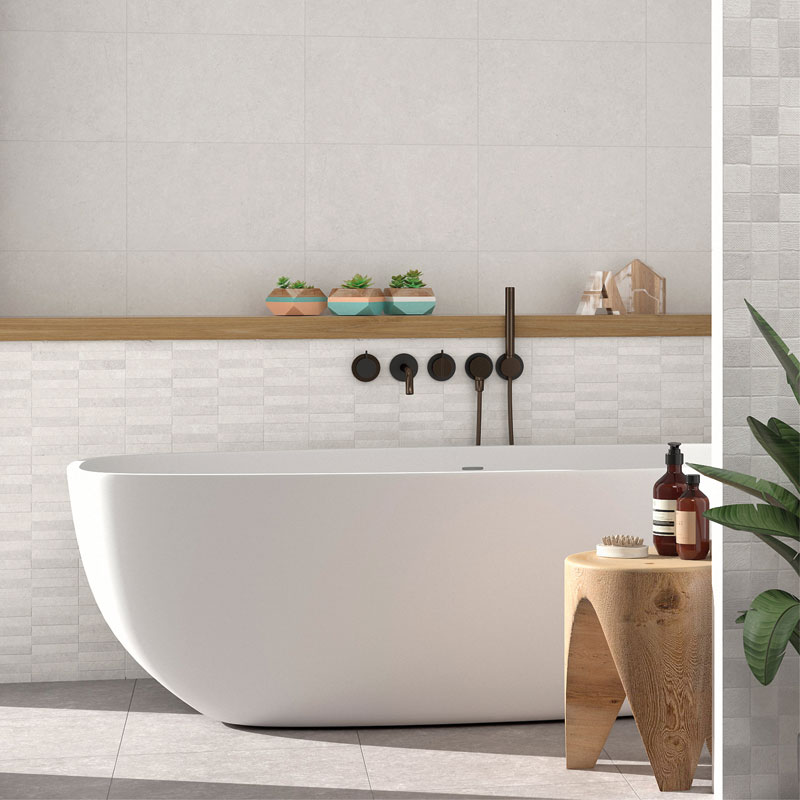 Kensington White 3D Rectangle Mosaic Tiles used in a bathroom with a free standing bath