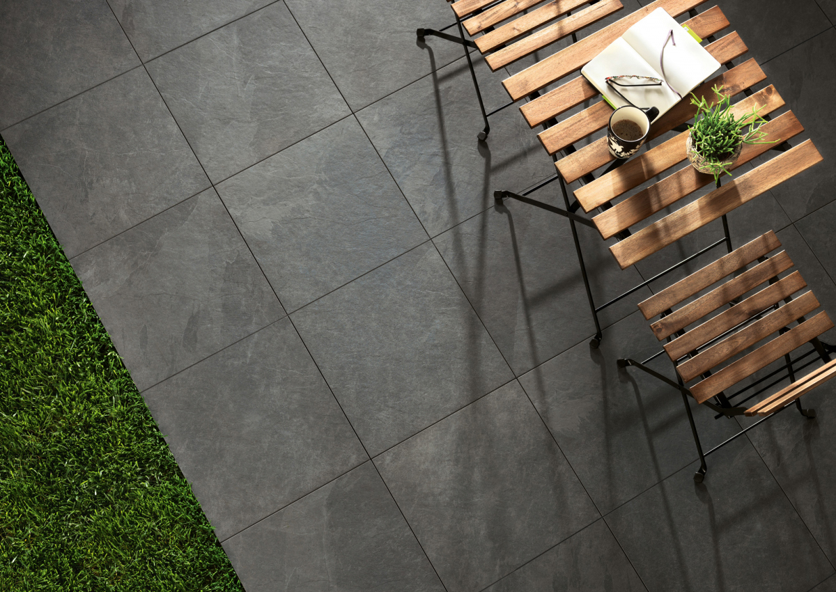 Dark grey stone effect porcelain paving tiles on a patio