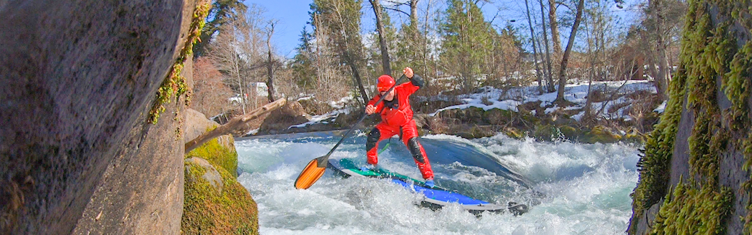 Paul Clark stand-up paddleboarding on whitewater