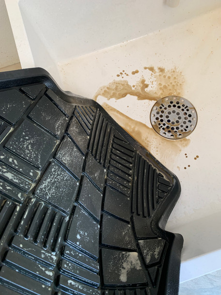 Rinsing dirt off of rubber floor mat