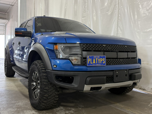The Platypus License Plate Mount shown on a 2013 Ford F-150 SVT Raptor