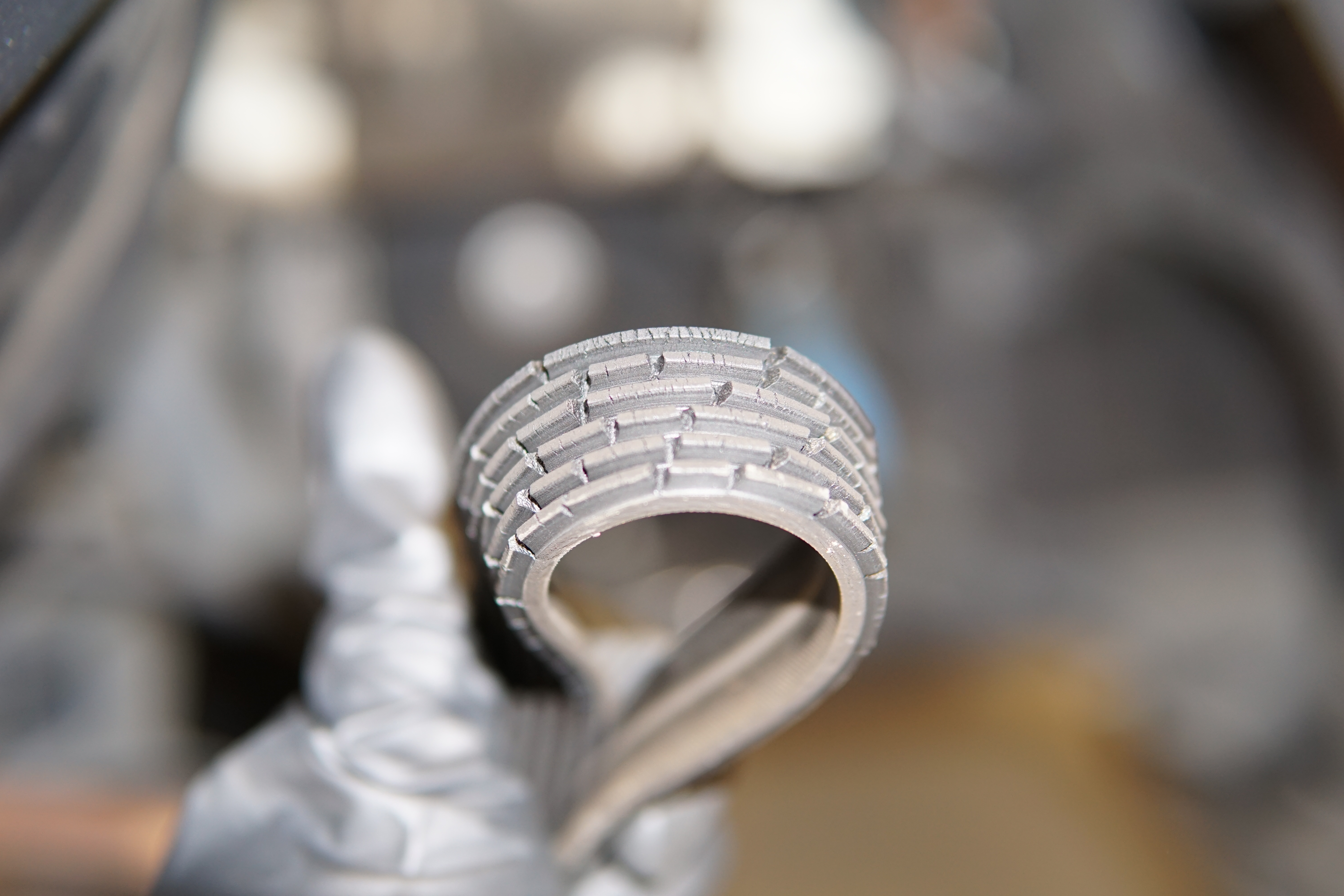 Close up of a worn and cracked serpentine belt showing rib damage