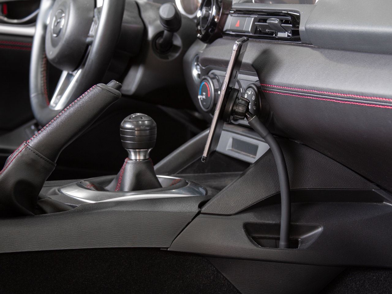The Gemini Flex Phone mount with Magnet attachment installed in a 2016 Mazda Miata.