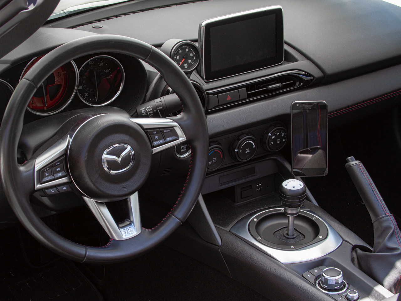 The Gemini Flex Phone mount with Magnet attachment installed in a 2016 Mazda Miata.