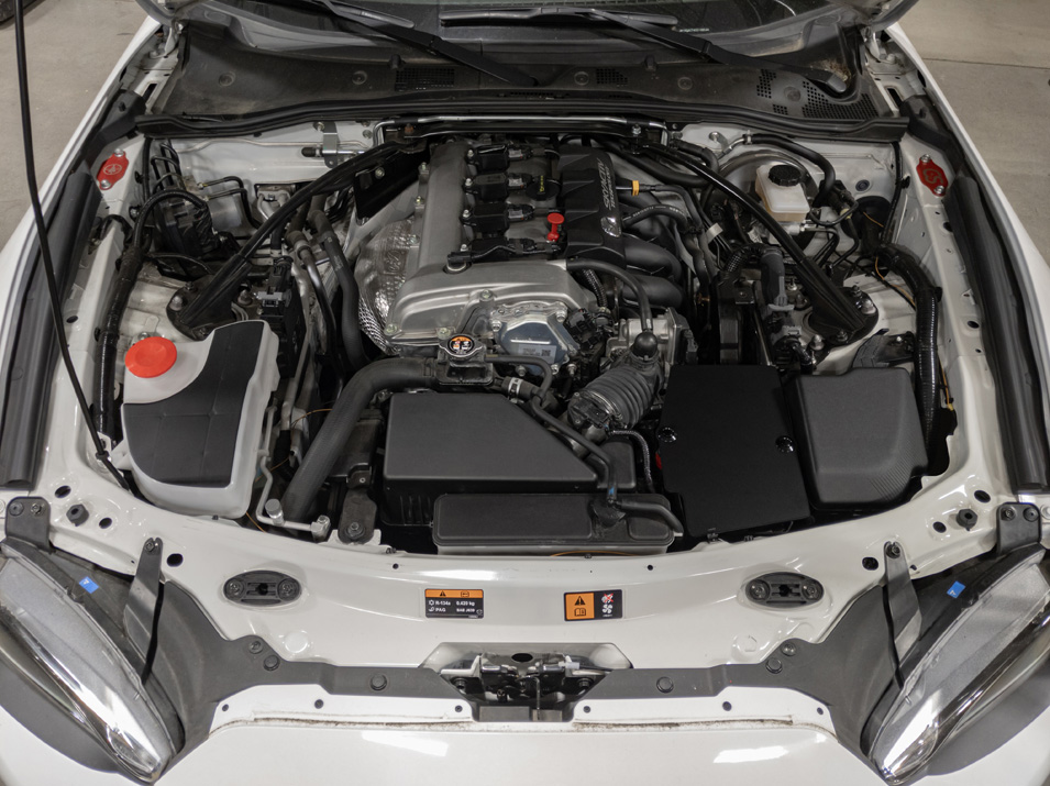 The CravenSpeed Battery Shield installed in a white 2016 Mazda MX-5 Miata ND.