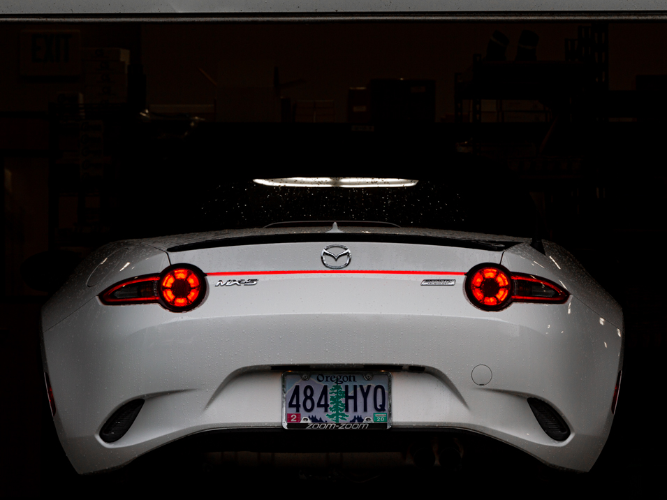 The MX5Things rear led running light installed on a white 2016 ND Miata