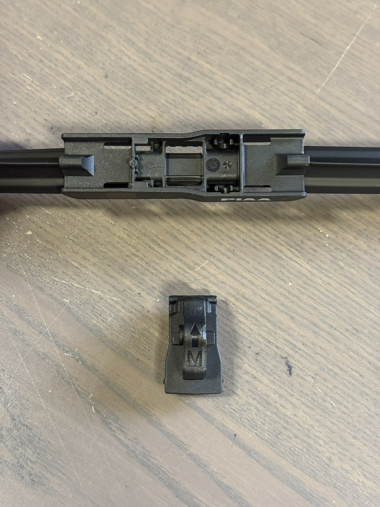 Remove the adapter that comes pre-installed on the PIAA wiper blades, then install the M adapter. 