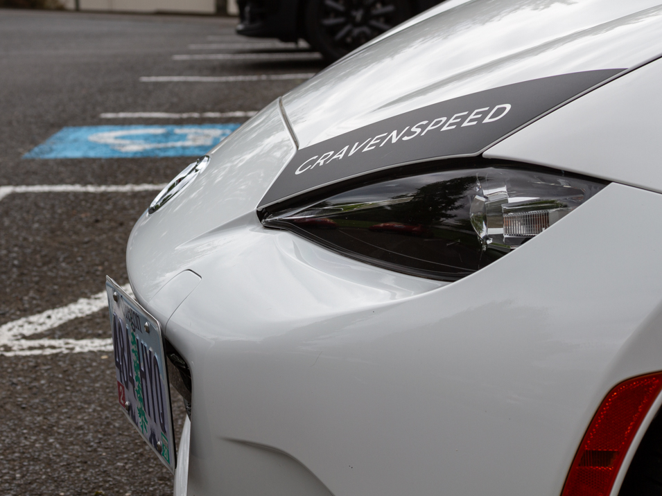 The CravenSpeed Graphics Kit and CravenSpeed Platypus License Plate Mount installed on a white 2016 ND Miata.
