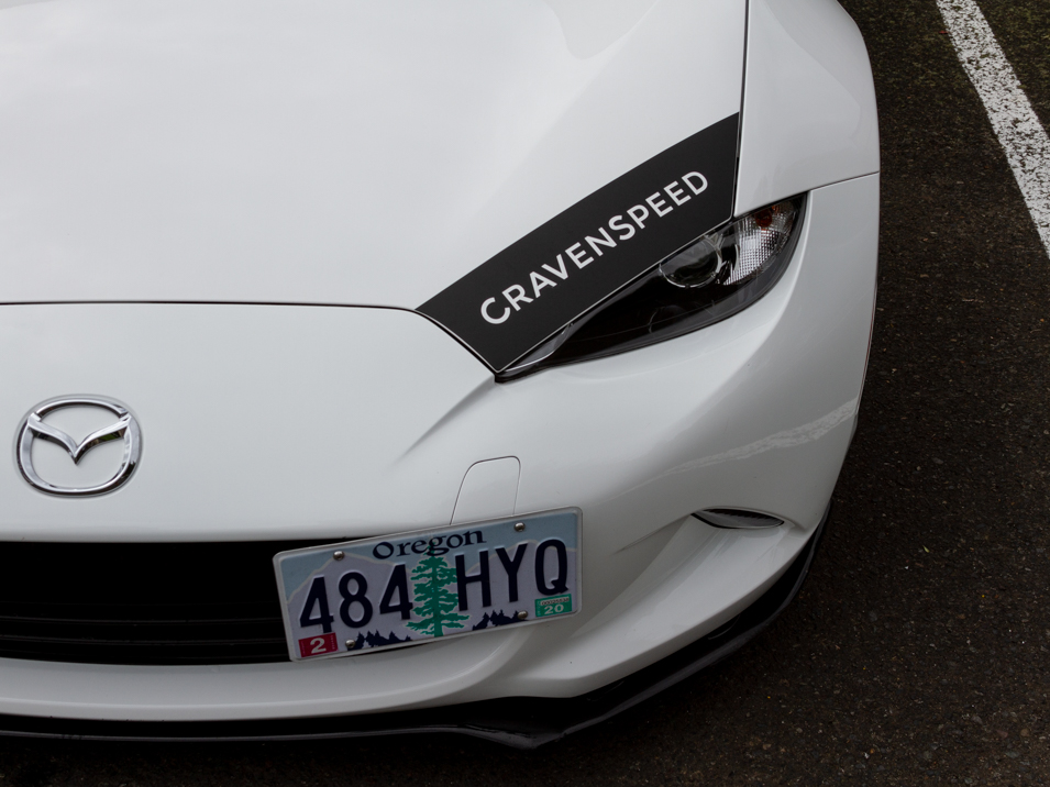 The CravenSpeed Graphics Kit and CravenSpeed Platypus License Plate Mount installed on a white 2016 ND Miata.