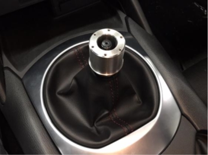 the trim piece and boot reinstalled over the shifter with the stainless steel core on the shifter shaft