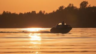 Boat on water at sunset