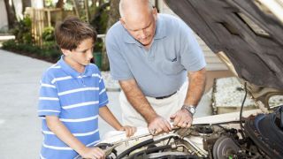 Father teaching son about auto mechanics