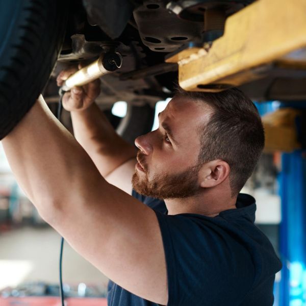 Mechanic inspecting car