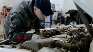 Mechanic inspecting engine