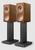 KEF R3 Meta Bookshelf Speakers in Walnut, on stands.


