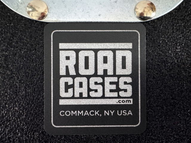 Steel ball corner and the Road Cases Commack, NY badge on a black laminate case