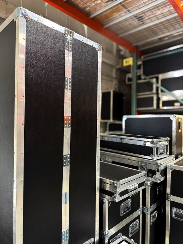 Tall custom road cases stacked in the Road Cases USA warehouse