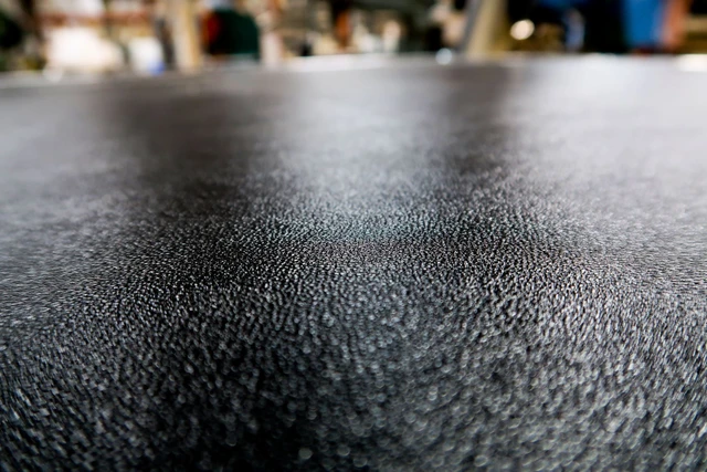 Close-up of the textured black laminate bonded to a plywood panel