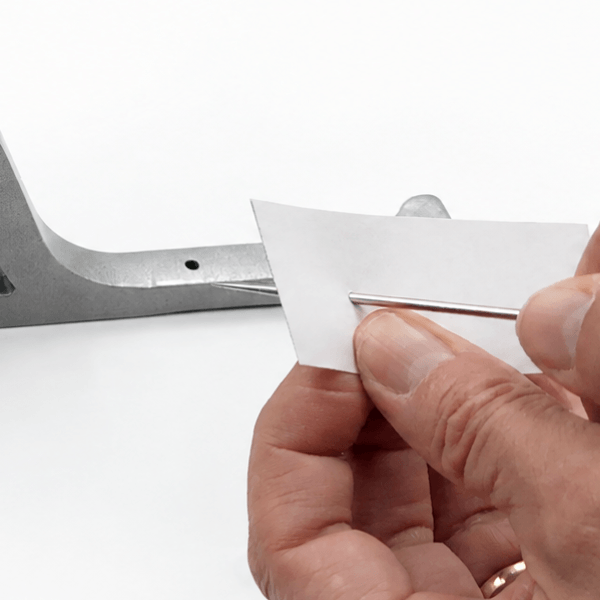 Using an awl to make a hole in fabric