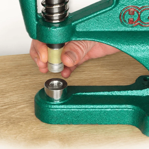 Installing the upper cap die in the DK93 Table Press